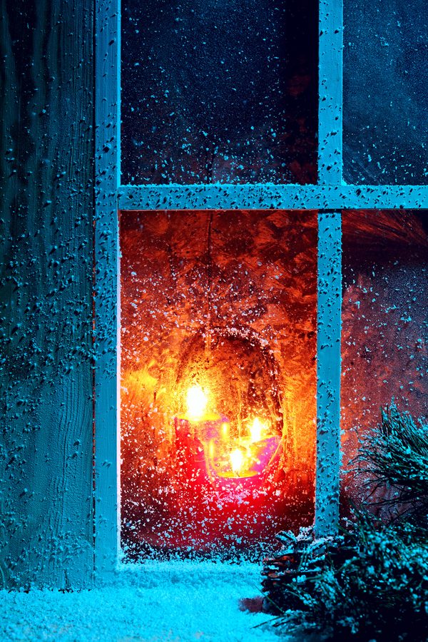 Christmas night! Frozen window burning candles
