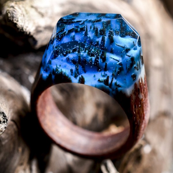 Enchanting miniature worlds inside wooden rings by Secret Wood