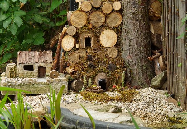 George the Mouse in a log pile house