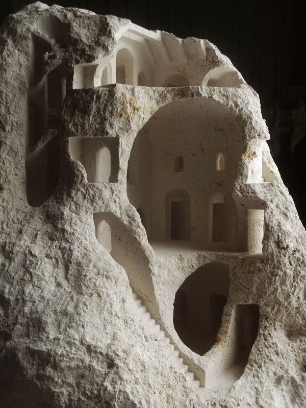 Miniature architectural structures carved into raw stone by Matthew Simmonds
